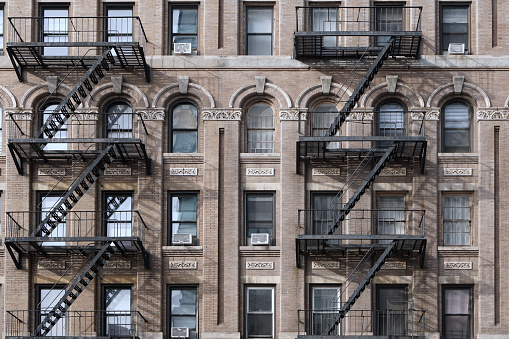 Old New York City Apartment building with external fire escape ladders