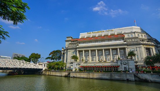 Singapore - Feb 9, 2018. Famous Fullerton Hotel with riverscene in Singapore. Singapore is global financial center with a tropical climate and multicultural population.