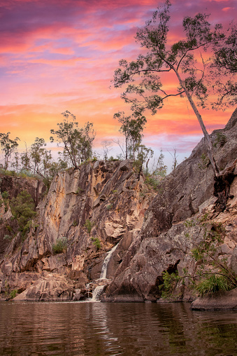 Pink sunset sky at Crows Nest Falls in Queensland, Australia in the natural bush area with bright, pastel landscape view with lake, dam, billabong in wilderness area