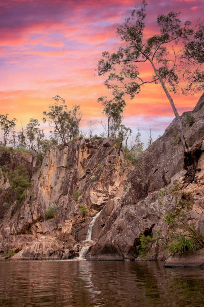 Scenic landscape in Australia during sunset Pink sunset sky at Crows Nest Falls in Queensland, Australia in the natural bush area with bright, pastel landscape view with lake, dam, billabong in wilderness area natural pattern pattern nature rock stock pictures, royalty-free photos & images