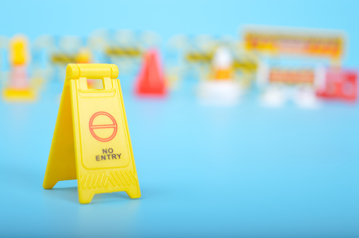 Yellow No Entry sign isolated on a blue background.