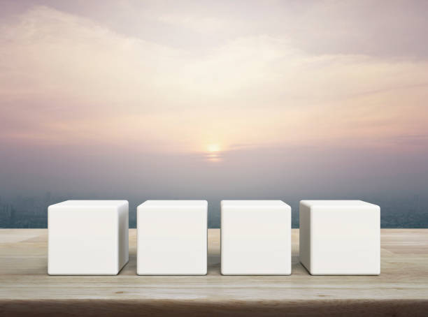 istock Four white block cubes on wooden table 1497566526