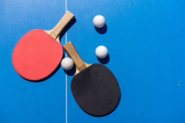 istock ping pong rackets and balls on a blue background, save space, sport and hobby. 1497571474