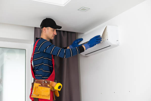 istock Rear View Of A Man Cleaning Air Conditioning System. 1497573183