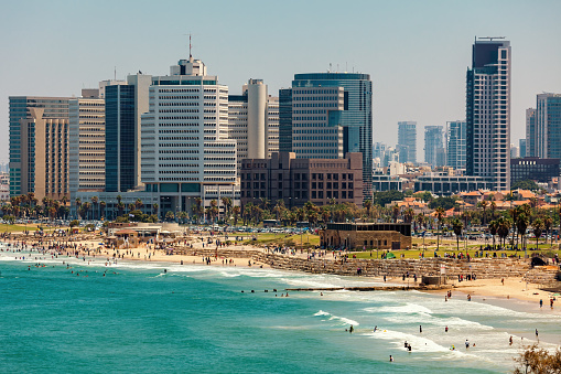 View of modern buildings and promenade along the shore of the Mediterranean sea in Tel Aviv, Israel.