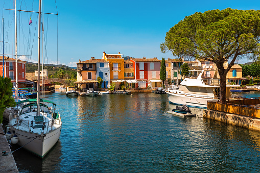 Yachts on the canal and colorful residential houses in the town of Port Grimaud on French Riviera.