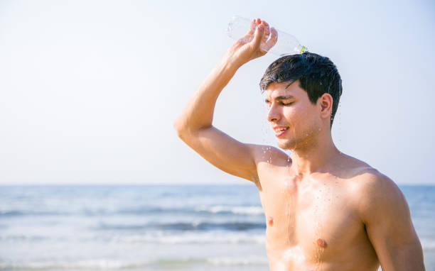 portrait of handsome sexy caucasian man wet on beach. young healthy skin sun tan male with slim fit body. beauty happy guy relax enjoy holiday travel vacation. 20s fitness caucasian man at the beach. - shirtless men 20s adult imagens e fotografias de stock
