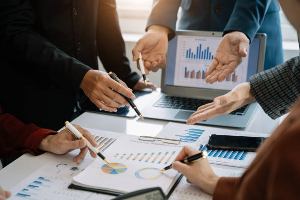 istock Businessmen team or financial data analysts working with tablets and laptop computers and data graphs together. Plan to analyzing projects in the office. 1497583530