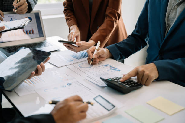 istock Businessmen team or financial data analysts working with tablets and laptop computers and data graphs together. Plan to analyzing projects in the office. 1497583539