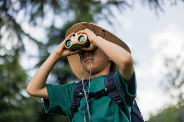 istock Asian boy is observing through a telescope outdoors 1497584747