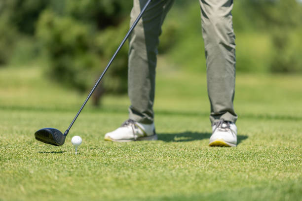 istock Golf course green. Golfer hits the ball with a club 1497595784