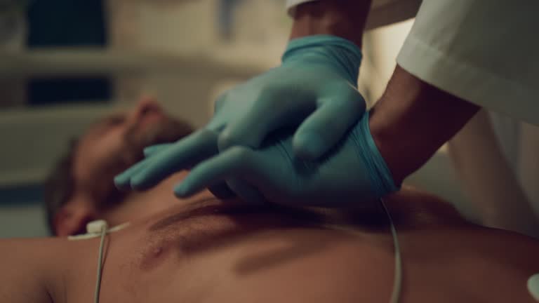 Closeup doctor doing heart massage to unconscious patient in hospital ward.