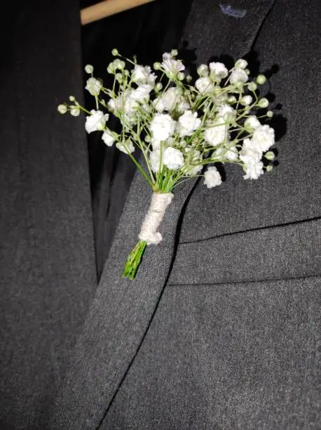 boutonniere of white flowers of the groom at a wedding