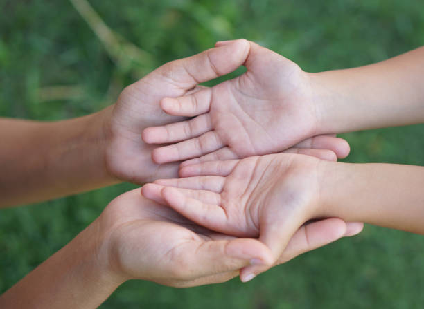 istock Mother and Childs holding hands to receive something 1497597284
