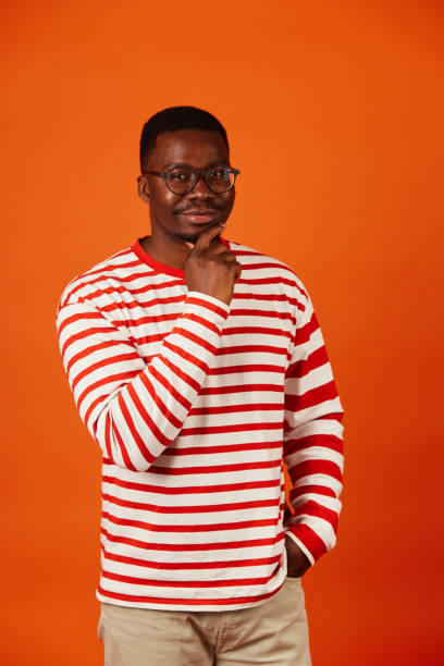 istock Pensive african American man in glasses looking at camera thinking 1497597402