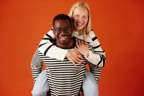 istock Joyful multiracial couple having fun together piggybacking 1497597412