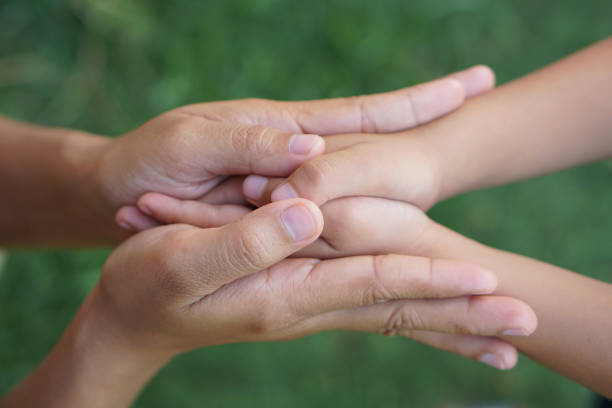 istock Mother and Childs holding hands to receive something 1497597560