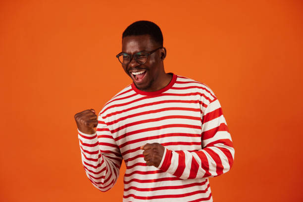 istock Black man making a winner's gesture with his hands clenched into fists 1497597651