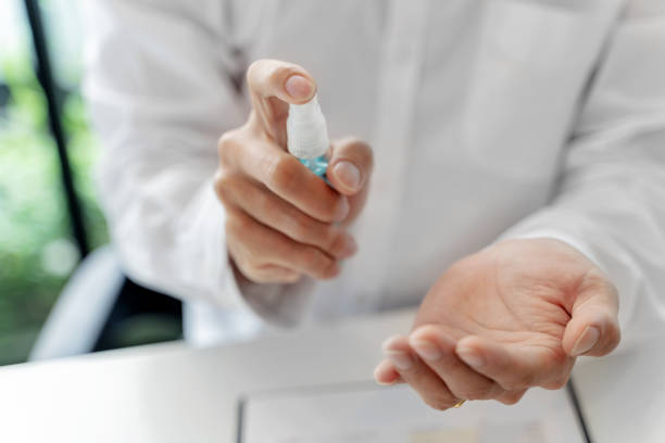 istock business people disinfectant spray Sanitize surfaces prevention in office. 1497602917