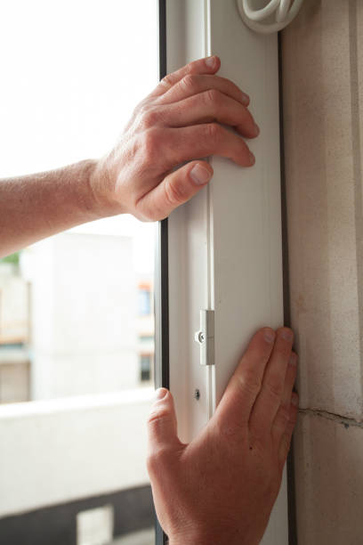 istock Close Up of two hands, applying a window Frame 1497603368