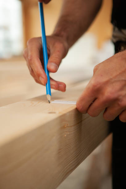 istock The carpenter is making a line on the Board 1497603418