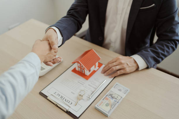 istock Real estate agent shaking hand with customer about house contract agreement. 1497604338