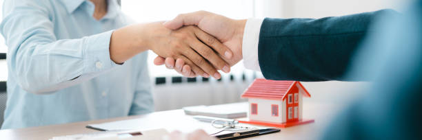 istock Real estate agent shaking hand with customer about house contract agreement. 1497604346