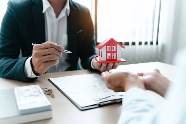istock Real estate agent broker and customer with loan or insurance contract documents. 1497604358