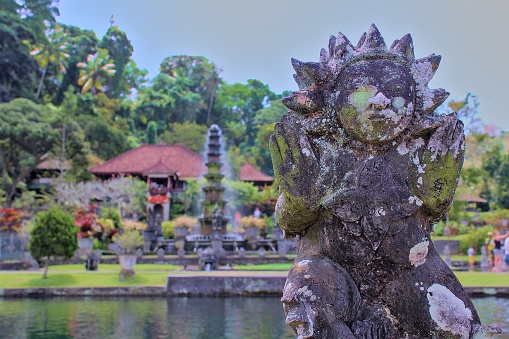 Statue with fountain in background at Tirta Gangga Water Gardens, Karangasem, Bali
