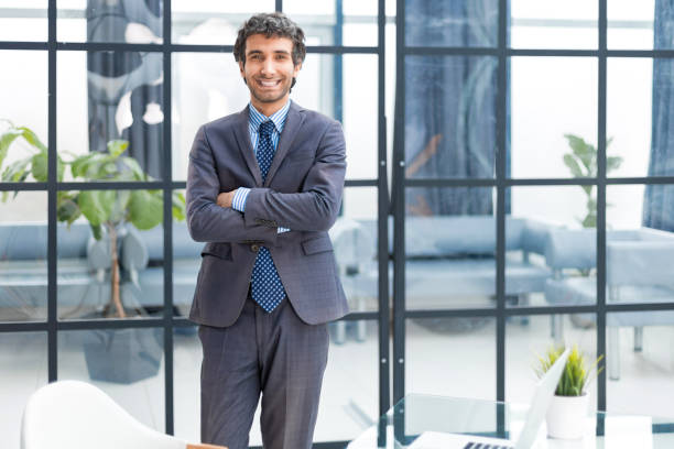 istock Handsome young businessman standing in modern office. 1497612959