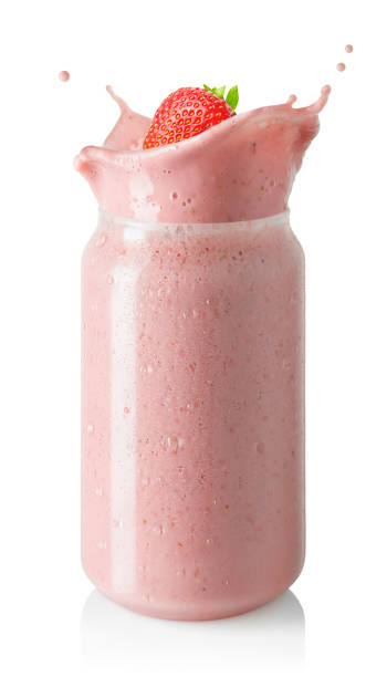 istock strawberry smoothie or milkshake with splash in glass jar isolated on white 1497612970