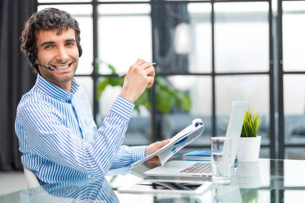 istock Smiling young business man having video call in office. 1497613911