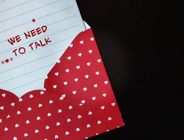 istock Red envelope with note written WE NEED TO TALK,concept of having difficult conversations to solve relationship conflict, workplace serious issues conflict discussion 1497614000