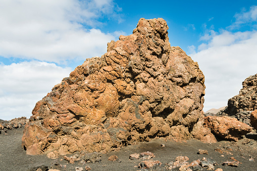 Close view of a large lava rock near the volcano Montana de las Lapas del Cuervo of Timanfaya in Lanzarote, Spain.