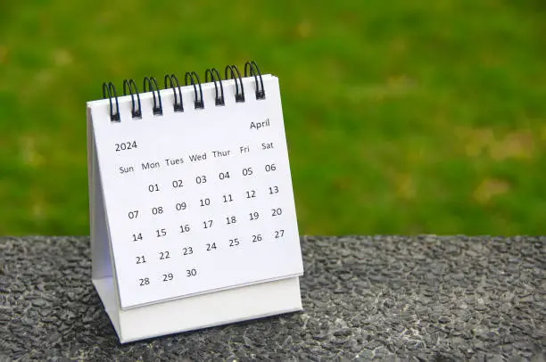 Photo of April 2024 table calendar with customizable space for text. Copy space.