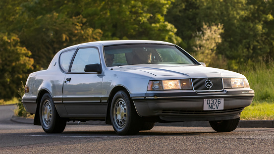 Stony Stratford,UK - June 4th 2023: 1987 FORD MERCURY COUGAR classic car travelling on an English country road.