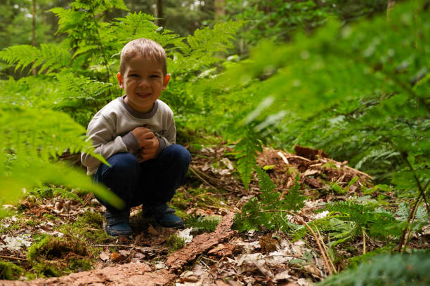 istock Lonely boy sitting in the woods, lost sad child. Selective focus. 1497617180