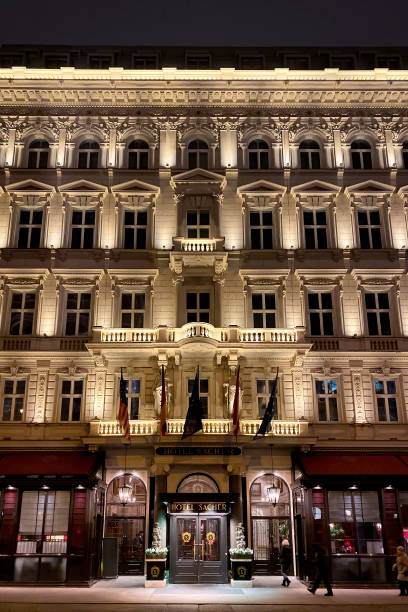 vue en contre-plongée illuminée célèbre hôtel sacher, vienne, autriche - winter palace photos et images de collection