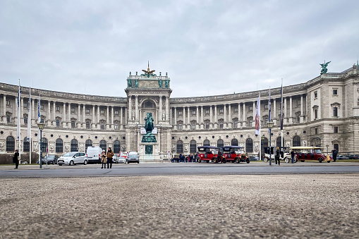 Vienna, Austria - January 16, 2020: Low angle view of the Hofburg Palace from Heldenplatz square in winter against cloudy sky