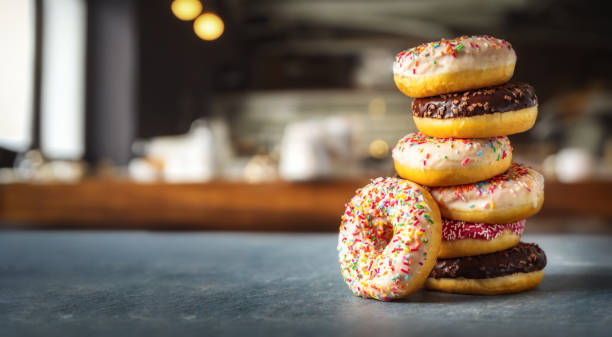 Different multicolored sweet donuts donuts with icing and sprinkles with copy space