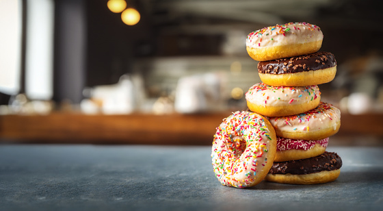 Set of different multicolored sweet donuts donuts with icing and sprinkles with copy space