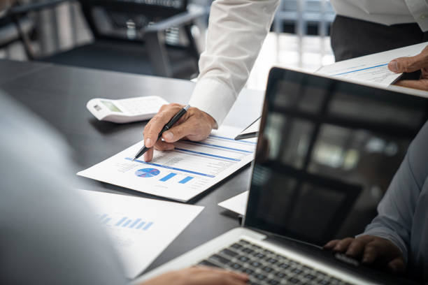 istock Team leader coach teach young workers explain on paper for business plan listen talkative coworker and discussing new project presentation Serious professional advisor consulting in office 1497620210
