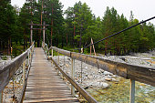 Suspended wooden bridge over the river.