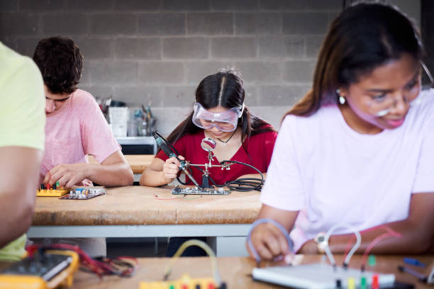 istock A group of technical college students are in the classroom studying, practicing soldering pieces of hardware on a circuit board. Concept of higher engineering studies. Development and innovation. 1497629746