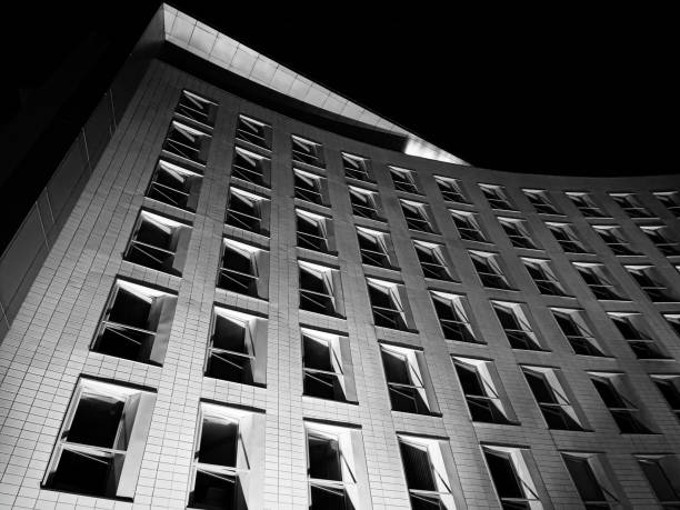 istock White office building with rows of open windows at night 1497632539