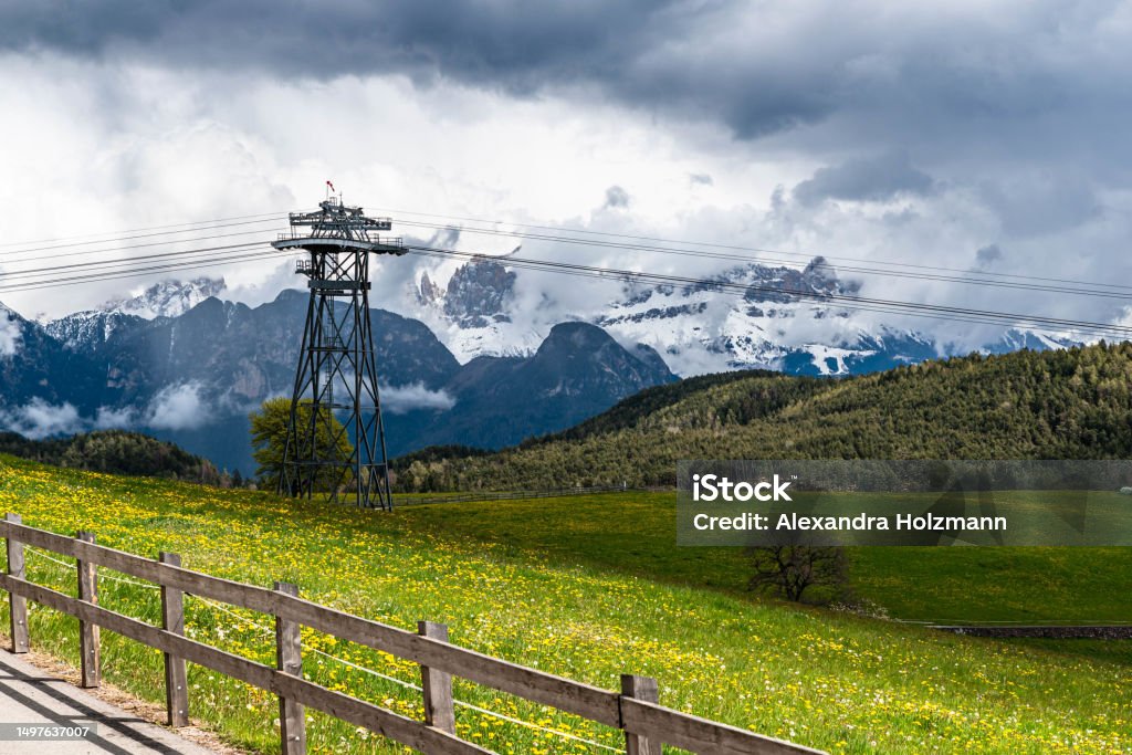 dark clouds over the bozen gondola lift the summer sun's rays are covered by a dark rain cloud. A promising view of the mountain scenery from the gondolas Alto Adige - Italy Stock Photo