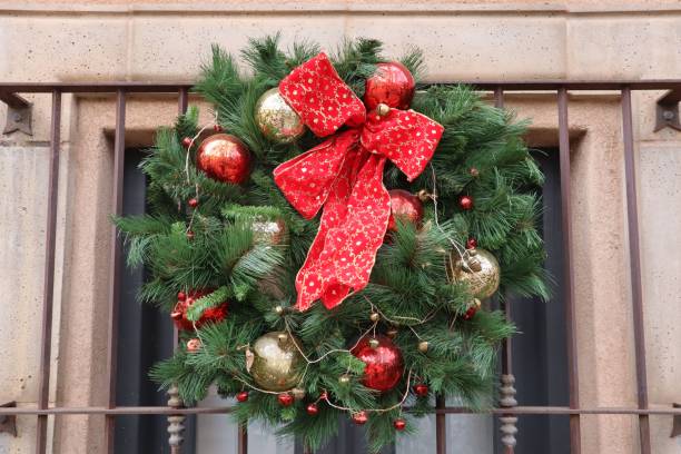 istock a wreath hung on a window next to metal bars on a building 1497637139