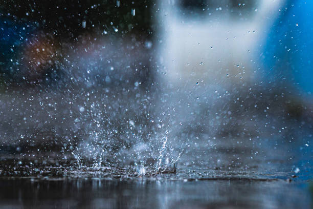 istock Raindrops on asphalt. Torrential rain. Rainy weather. Water drops 1497638174