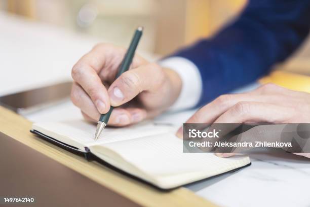Inscribing Message A Mans Hand Inscribing In A Notepad Captured Closely With A Vague ...