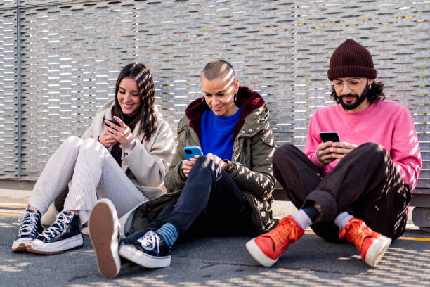 istock friends scrolling through social media with phone 1497643733